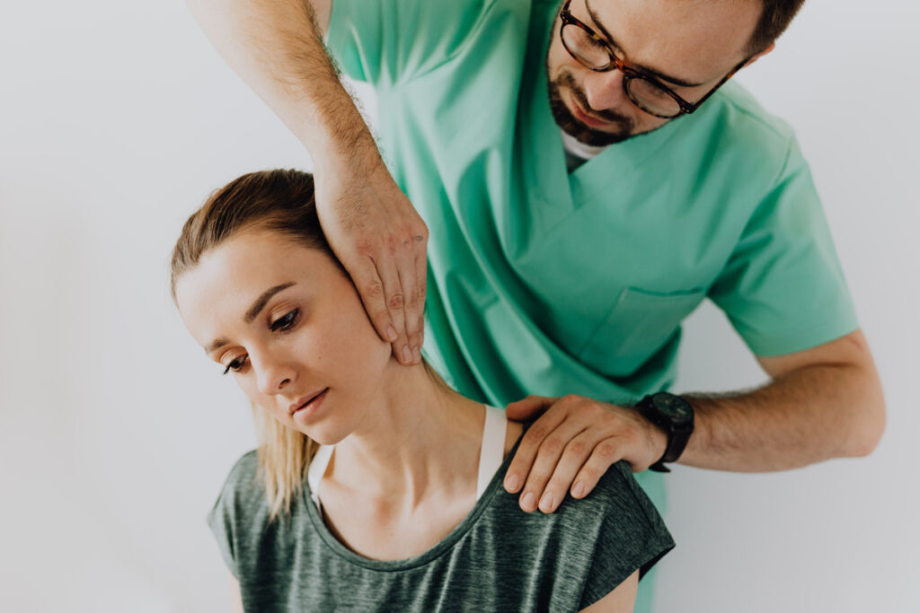 Physiotherapist demonstrating neck pain relief exercise