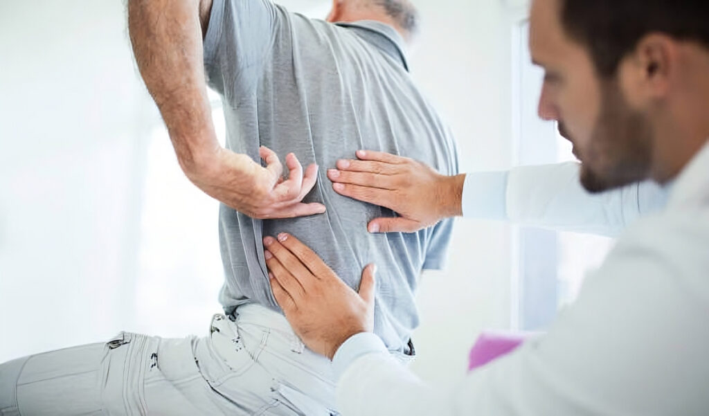 Physiotherapist assisting patient with sciatica pain